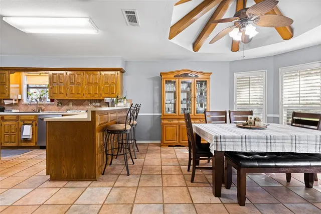 a view of a dining room with furniture and chandelier