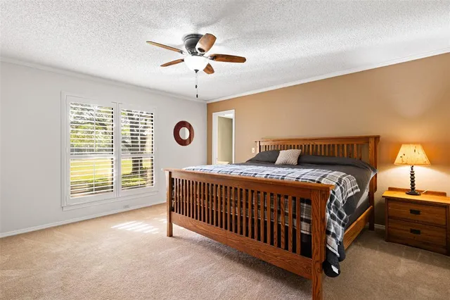 a spacious bedroom with a bed and a chandelier