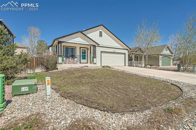 8234 Linderman Road Peyton, CO 80831 - Photo 23 of 24 View of front of property with a garage and covered porch