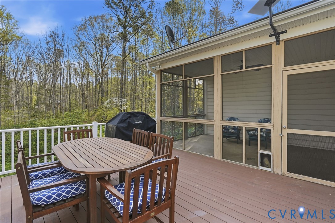 14430 Overlook Ridge Lane Beaverdam, VA 23015 - Photo 6 of 71 a view of a roof deck with table and chairs with wooden floor and fence