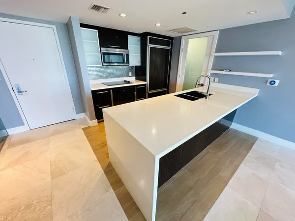 a kitchen with stainless steel appliances a sink and a refrigerator