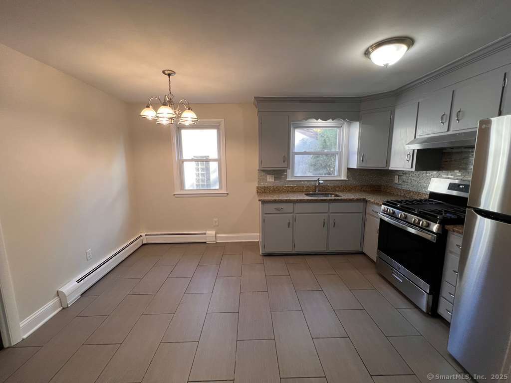 193 City View Avenue Bridgeport, CT 06606 - Photo 12 of 16 a kitchen with granite countertop a sink cabinets and stainless steel appliances