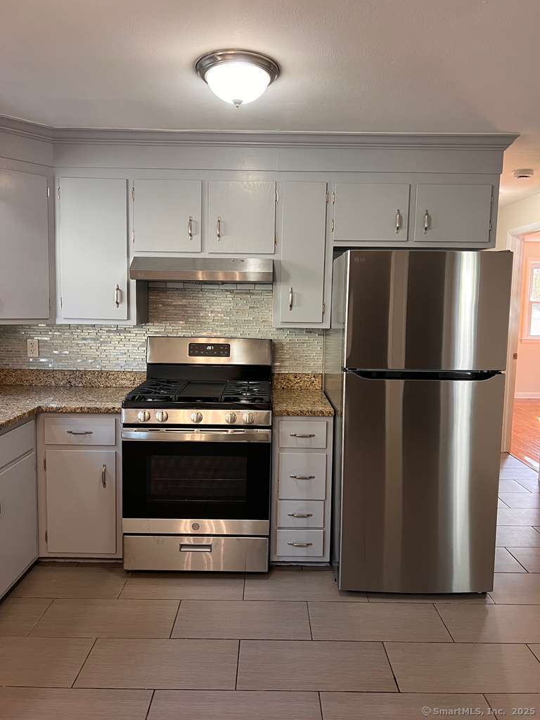 193 City View Avenue Bridgeport, CT 06606 - Photo 14 of 16 a kitchen with cabinets and stainless steel appliances