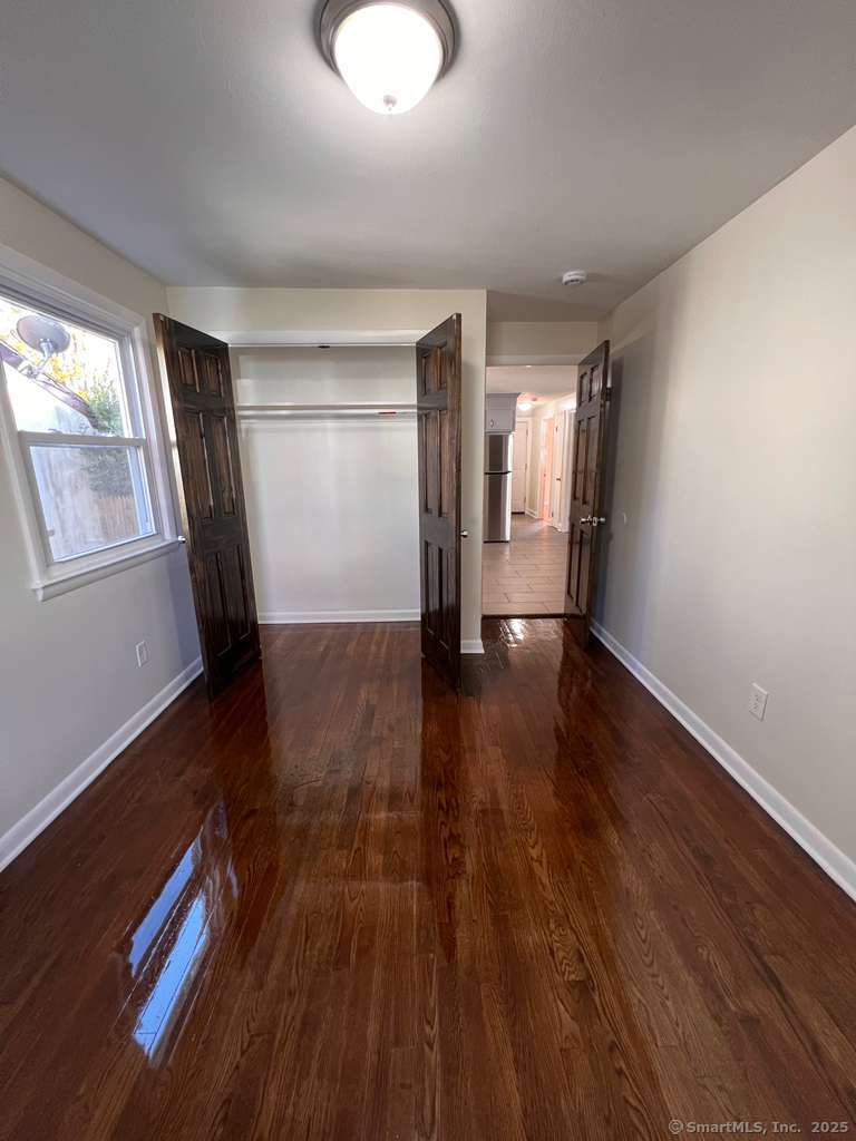 193 City View Avenue Bridgeport, CT 06606 - Photo 16 of 16 wooden floor in an empty room with a window