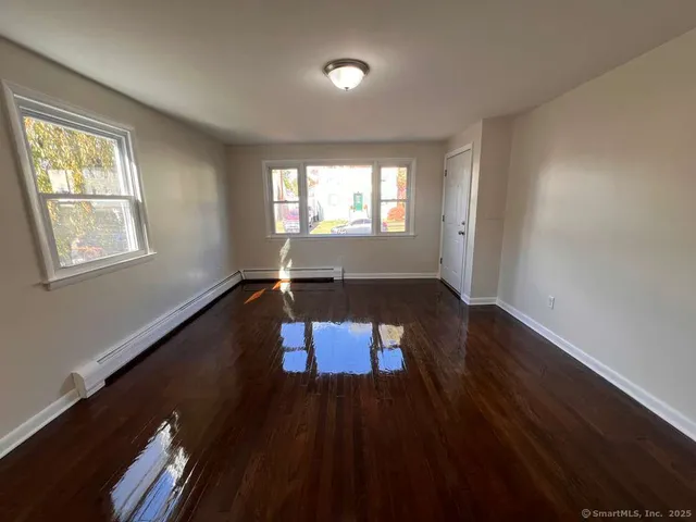 wooden floor in an empty room with a window
