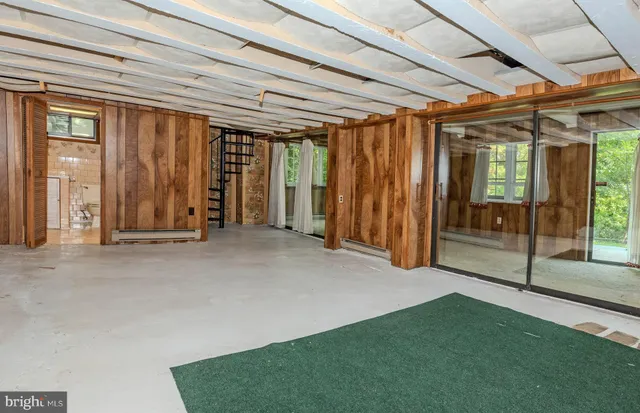 an aerial view of green landscape with trees houses and lake view