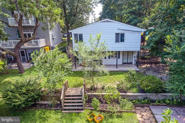 a view of a roof deck with table and chairs a barbeque with wooden floor and fence