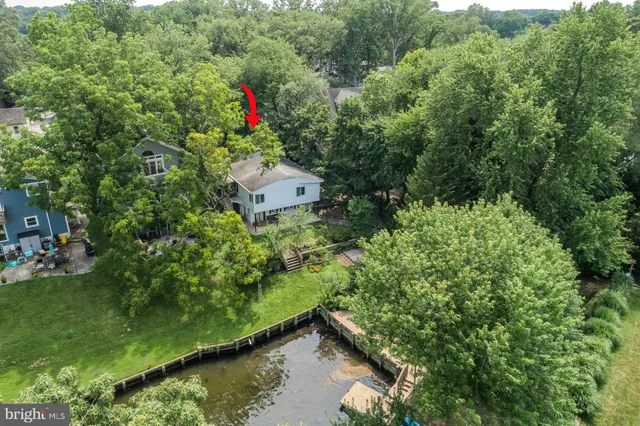 a view of a roof deck with table and chairs a barbeque with wooden floor and fence