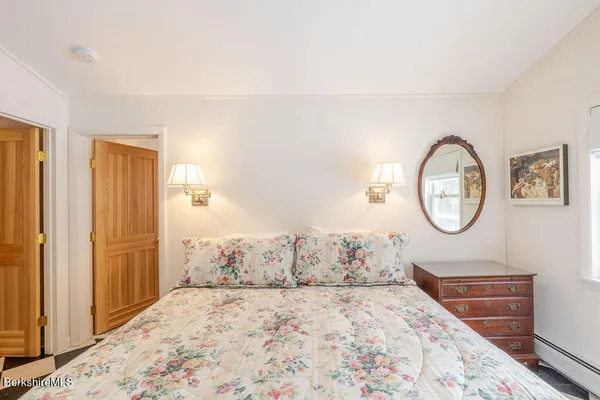 a bedroom with a large bed and a closet with mirror
