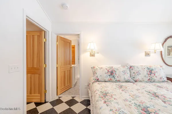 a bedroom with a bed and a mirror