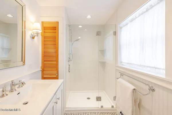 a bathroom with a tub sink and a shower