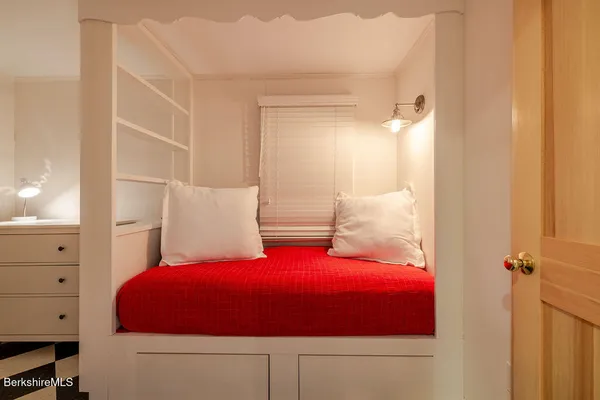 a bedroom with a bed and a cabinets