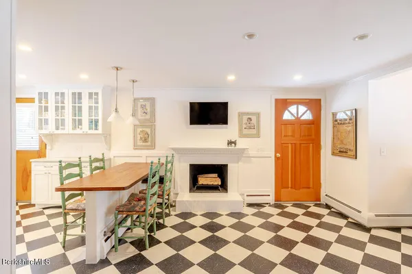 a living room with a fireplace a flat screen tv and a window