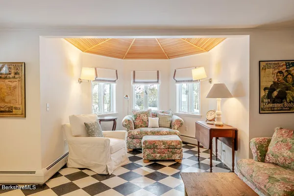 a living room with furniture and a lamp