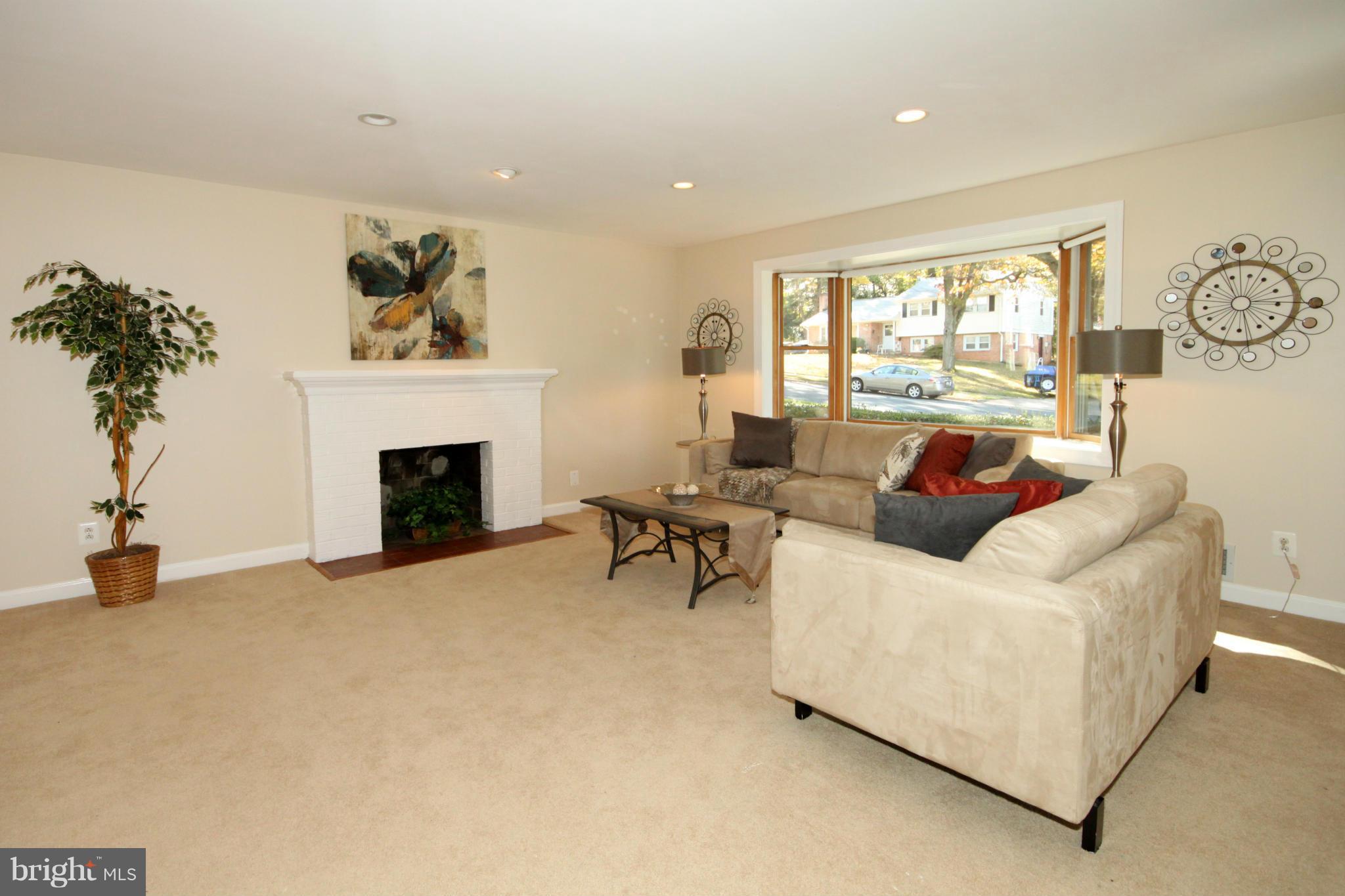 5404 Moultrie Road Springfield, VA 22151 - Photo 3 of 30 a living room with furniture and a fireplace