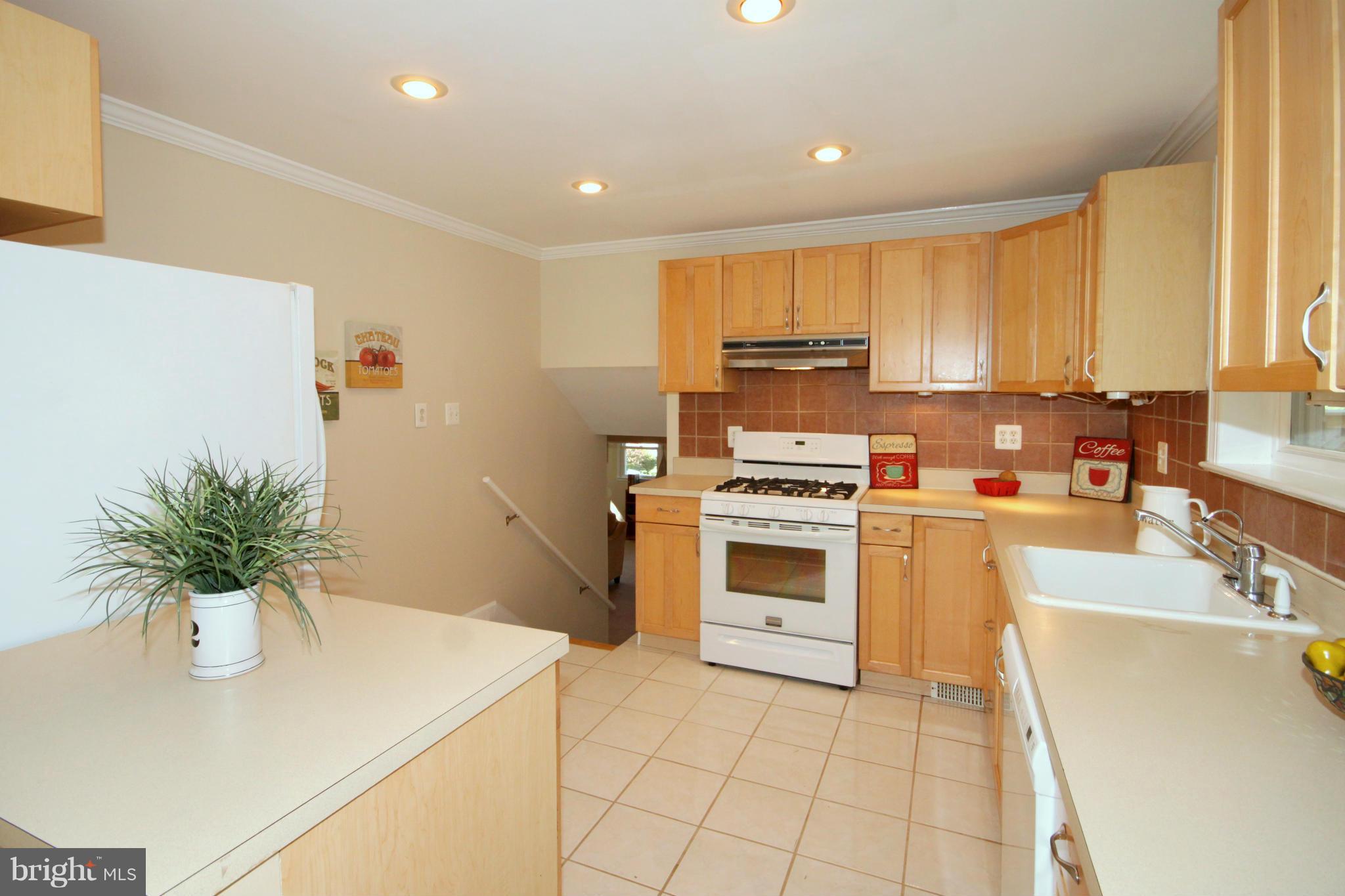 5404 Moultrie Road Springfield, VA 22151 - Photo 7 of 30 a kitchen with a sink a stove and cabinets