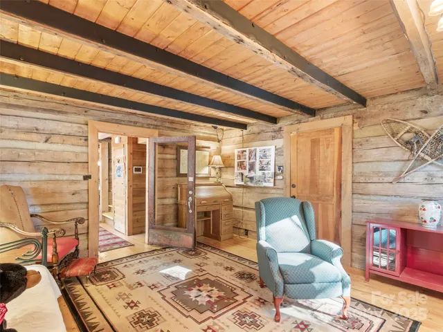 a view of walk in closet with window and chandelier