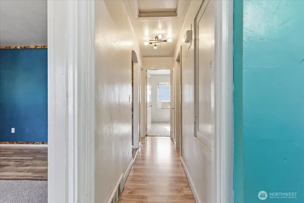 a view of a hallway with wooden floor