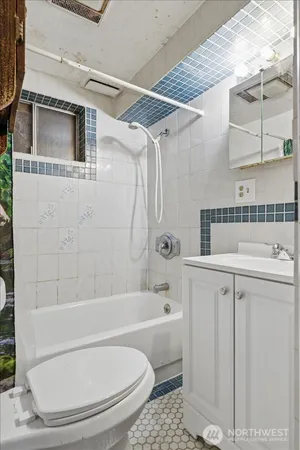 a bathroom with a sink a toilet and bathtub