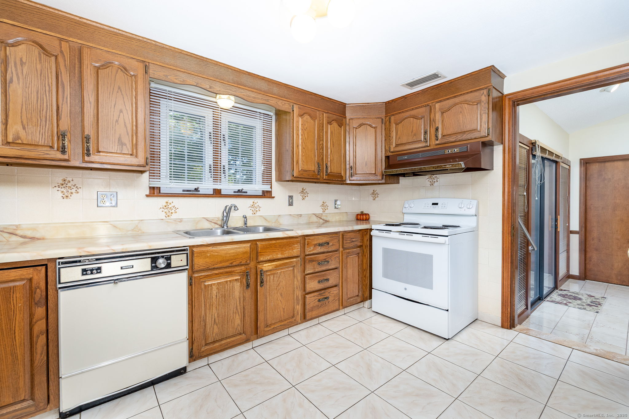 101 Collier Road Wethersfield, CT 06109 - Photo 14 of 40 a kitchen with granite countertop cabinets stainless steel appliances and a sink