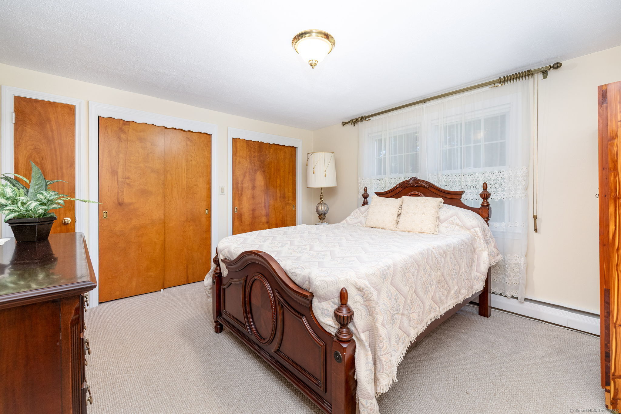 101 Collier Road Wethersfield, CT 06109 - Photo 20 of 40 a bedroom with a bed and a window