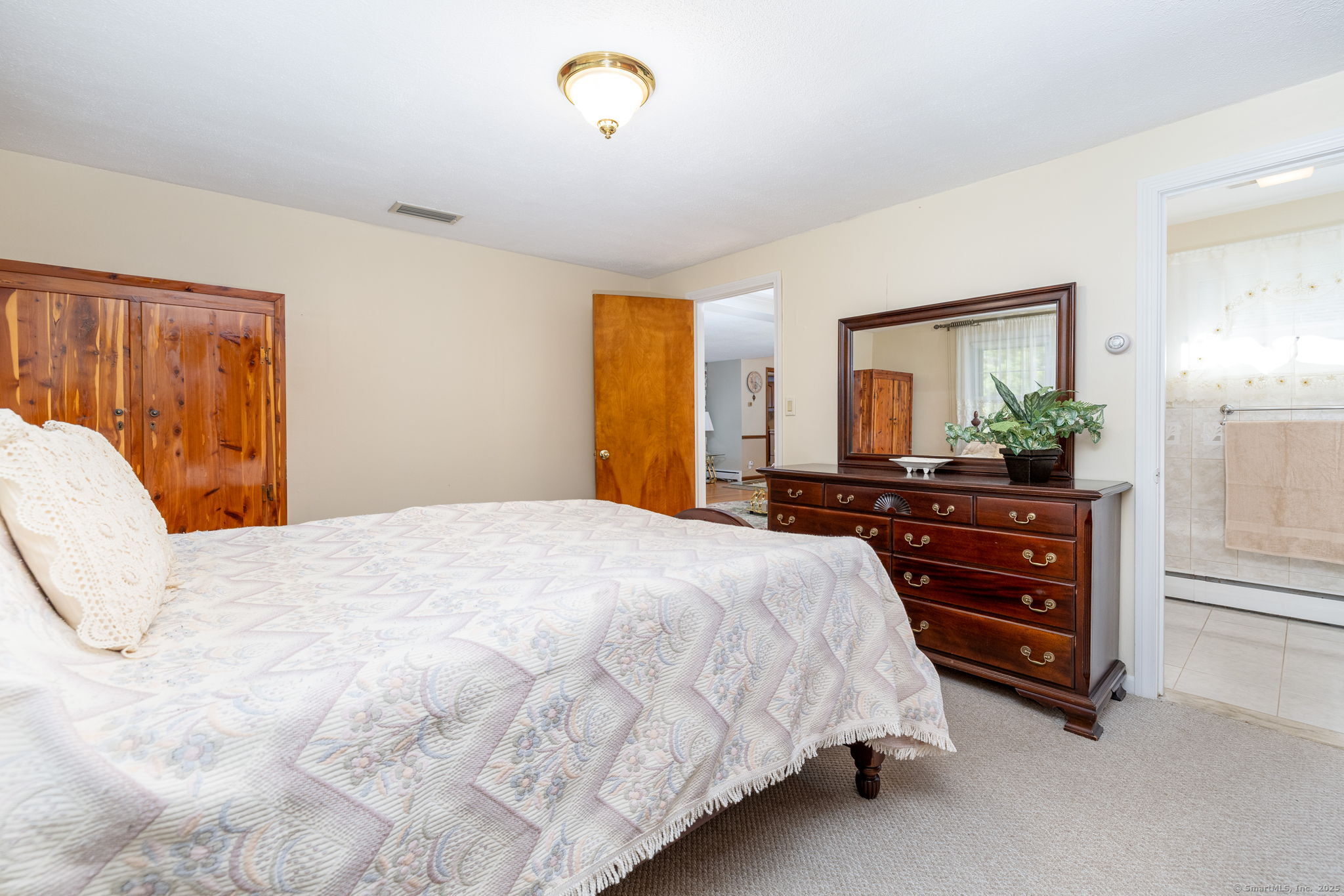 101 Collier Road Wethersfield, CT 06109 - Photo 21 of 40 a bedroom with a bed and a dresser
