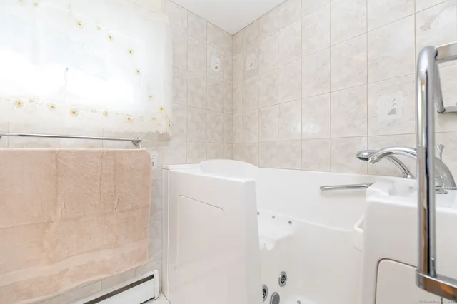 a bathroom with a bathtub and shower