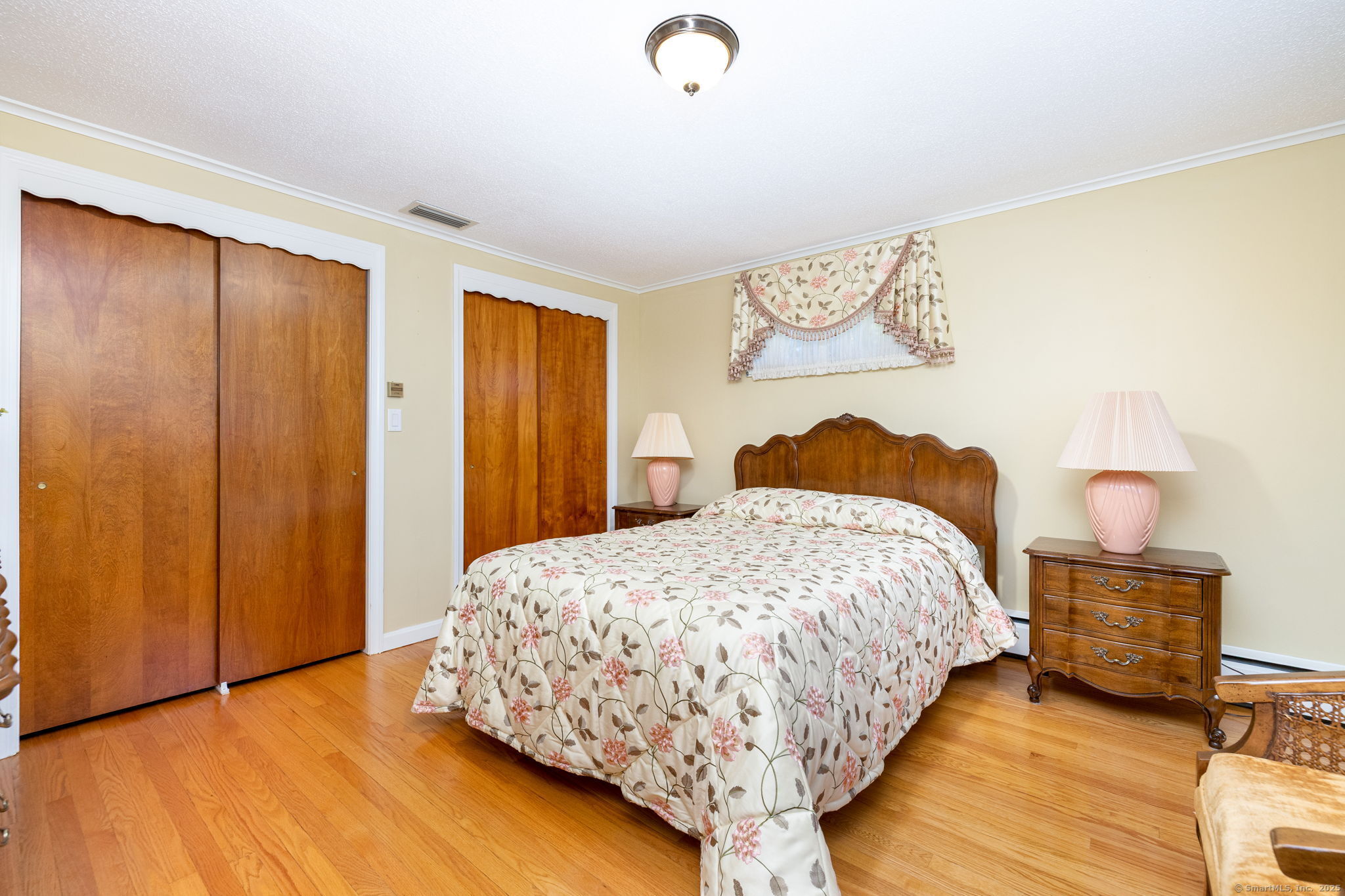 101 Collier Road Wethersfield, CT 06109 - Photo 24 of 40 a bedroom with a bed and a painting on the wall