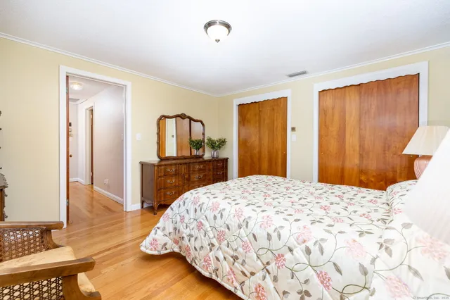 a bedroom with a bed and a dresser