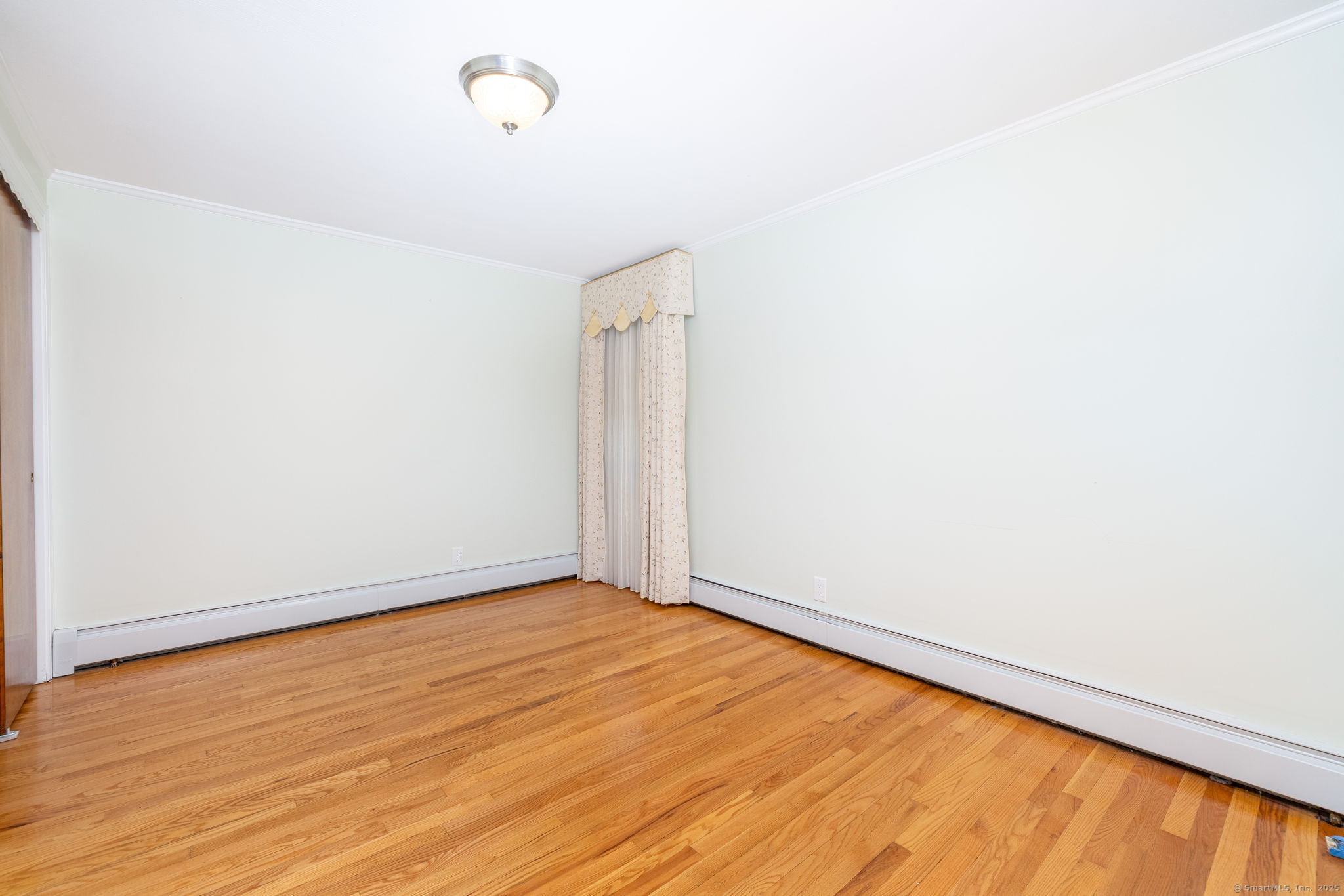 101 Collier Road Wethersfield, CT 06109 - Photo 26 of 40 a view of an empty room with wooden floor