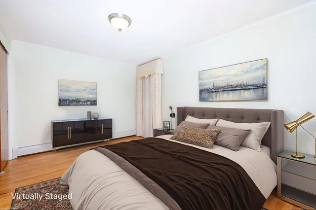 a bedroom with a bed and a lamp on dresser