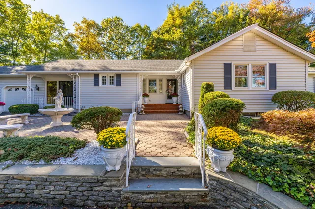 a front view of house with yard outdoor seating and green space