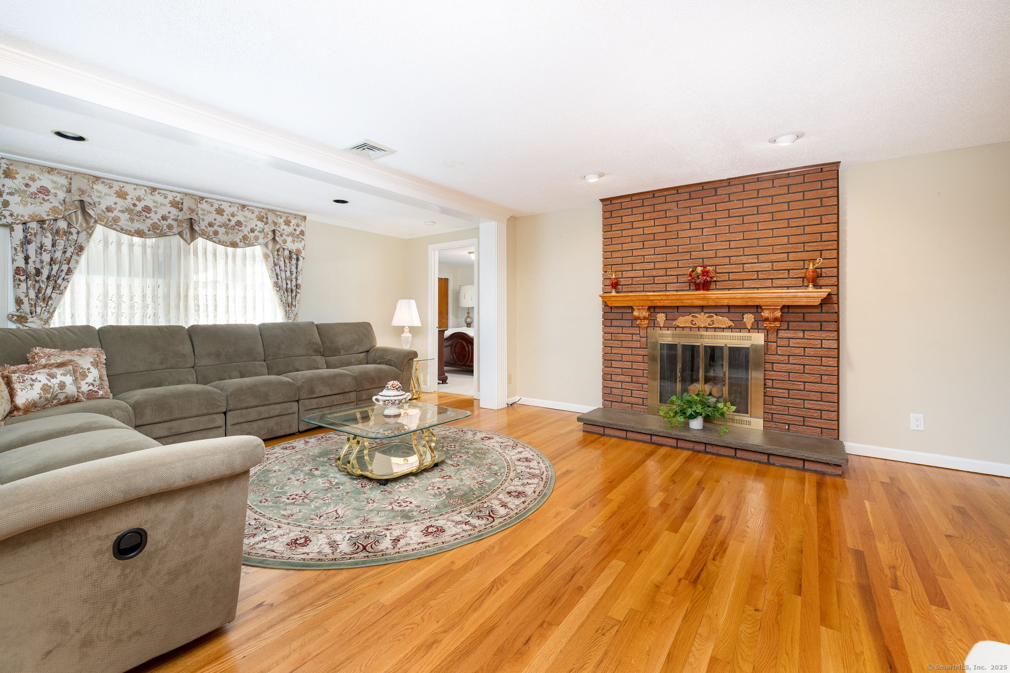 101 Collier Road Wethersfield, CT 06109 - Photo 9 of 40 a living room with furniture and a fireplace