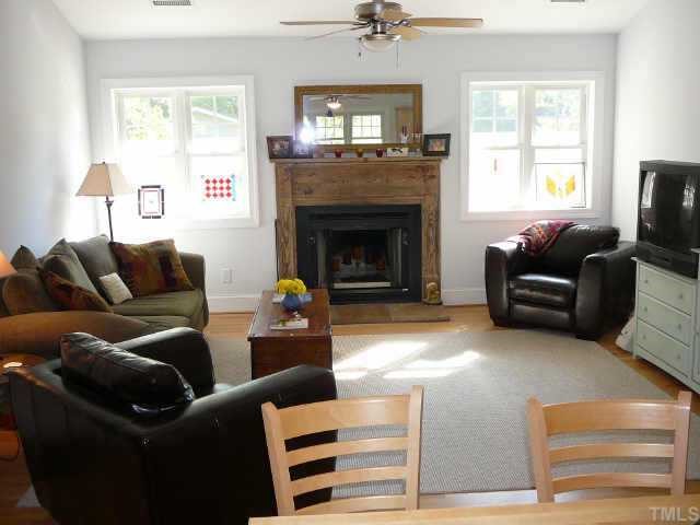 2126 Buckingham Road Raleigh, NC 27607 - Photo 3 of 11 a living room with furniture window and a fireplace