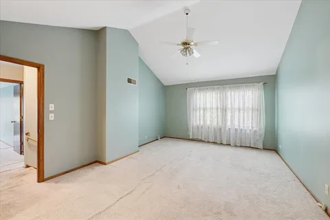 a view of an empty room with chandelier