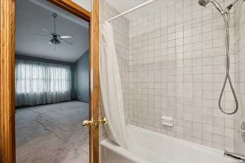 a bathroom with a bathtub and shower