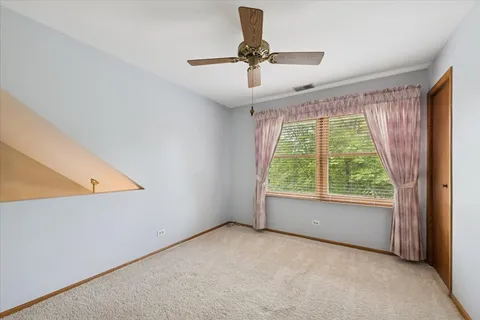 a view of room with window and ceiling fan