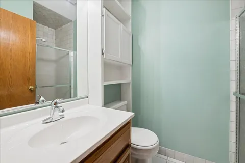 a bathroom with a sink a toilet and a mirror