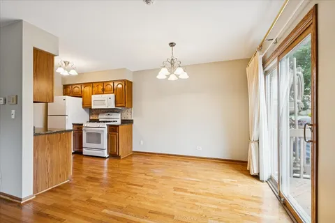 a view of a kitchen with a sink and dishwasher wooden floor