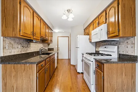 a kitchen with stainless steel appliances granite countertop a stove a sink and dishwasher