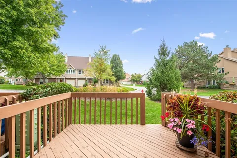 a view of a wooden chairs on the deck