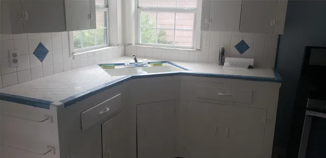 a bathroom with a sink vanity and a mirror