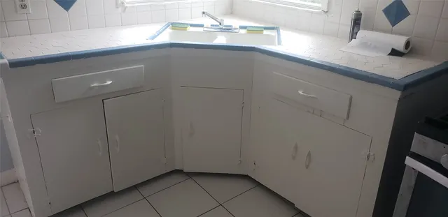 a close view of a sink cabinets and utility room