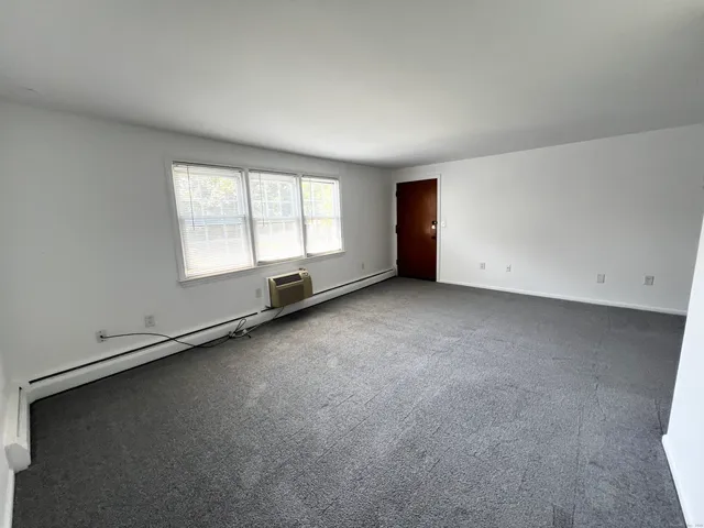 an empty room with a empty space and windows