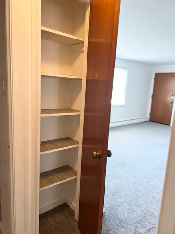 a view of room with a closet and wooden floor