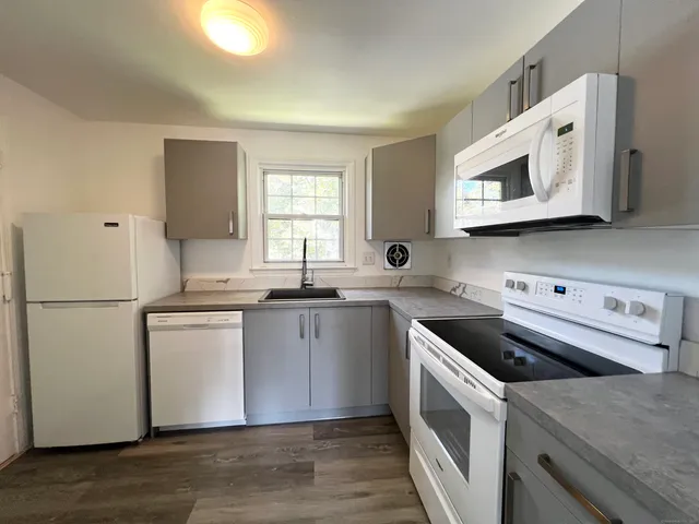 a kitchen with a sink cabinets and stainless steel appliances