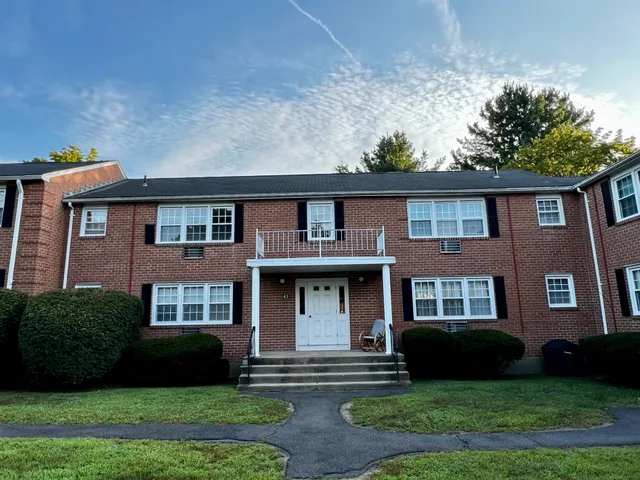 a front view of a house with yard and green space