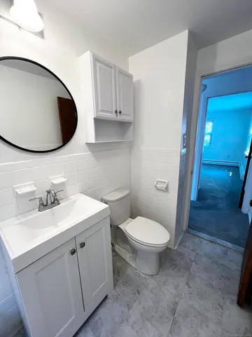 a bathroom with a toilet sink and mirror