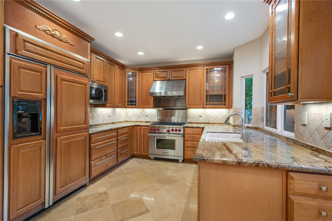 30 St Michael Dana Point, CA 92629 - Photo 14 of 33 a kitchen with granite countertop stainless steel appliances a stove sink and cabinets