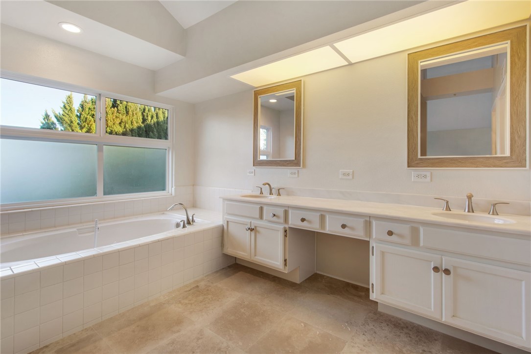 30 St Michael Dana Point, CA 92629 - Photo 22 of 33 a spacious bathroom with a double vanity sink a large mirror and a bathtub